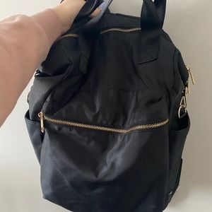 Black backpack with gold zipper details
